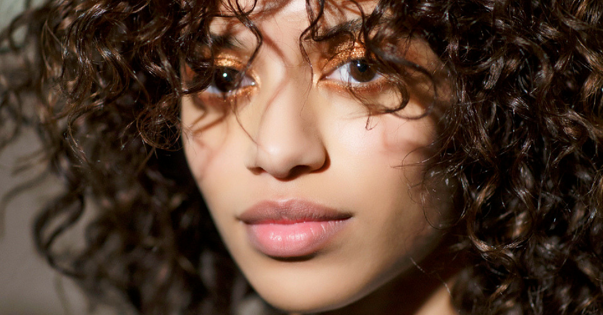 girl with perfect healthy curly hair after using conditioner